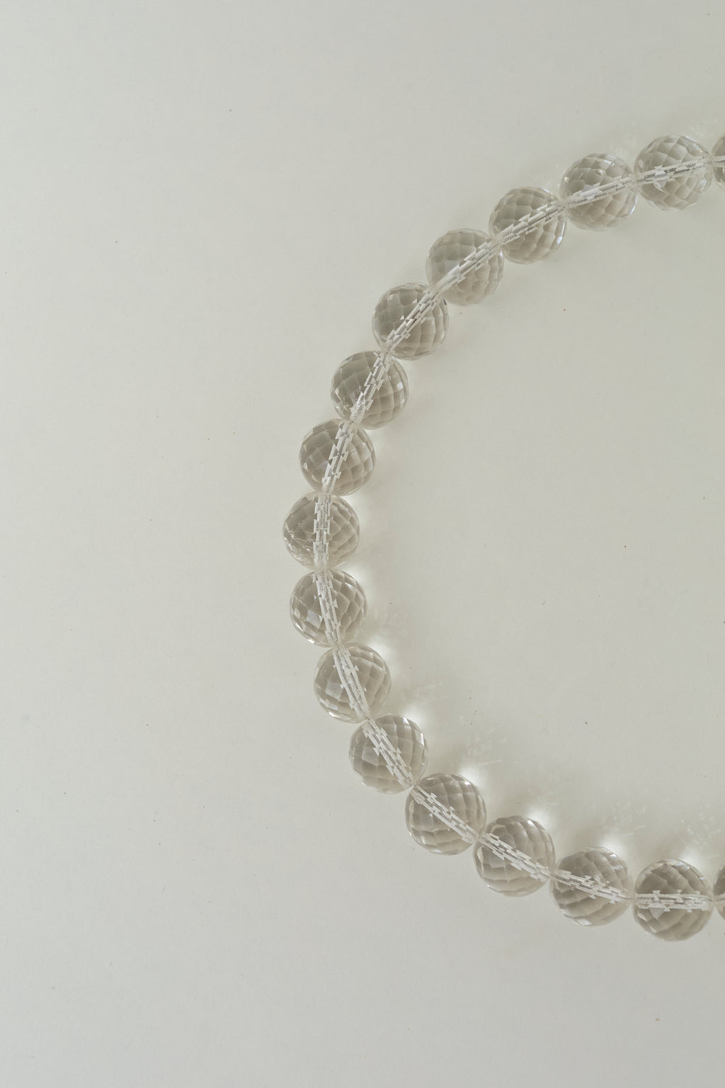 Transparent bead necklace with metallic thread