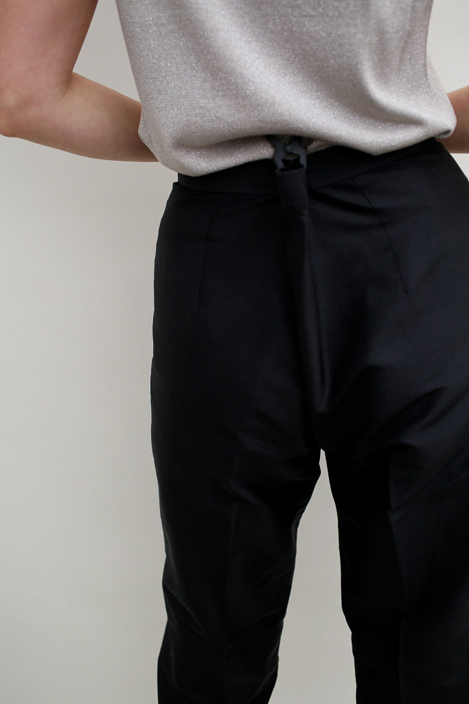 clipped black silk trousers on a model